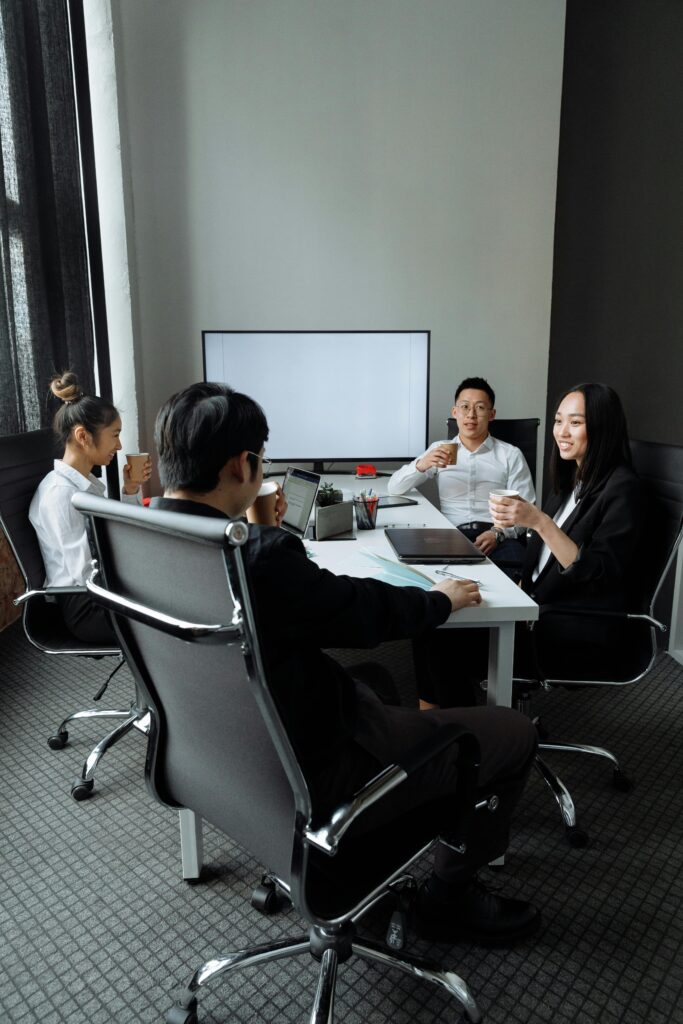 pexels photo 7652135 7652135 Group of professionals engaged in a collaborative meeting in a modern office setting.